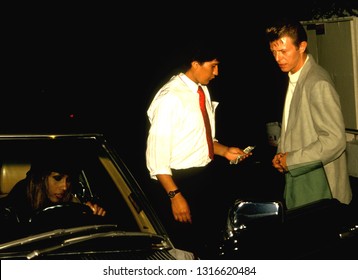 LOS ANGELES - Circa 1991: David Bowie And Wife Iman Leave Spago Restaurant.