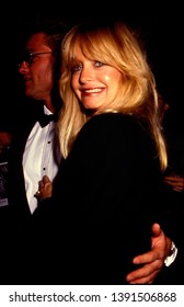 LOS ANGELES - Circa 1991: Goldie Hawn And Kurt Russell Leave The Four Seasons Hotel.
