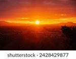 Los Angeles dawn sunshine bursting through layers of fog above the San Fernando Valley.  