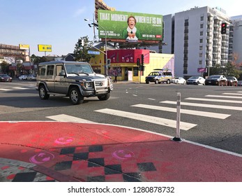 LOS ANGELES, Dec 12th, 2018: A Car Drives Past A Red Painted Curb Extension On Sunset Boulevard In West Hollywood, Part Of The Sunset Experience, A New Pilot Project To Improve Pedestrian Safety.