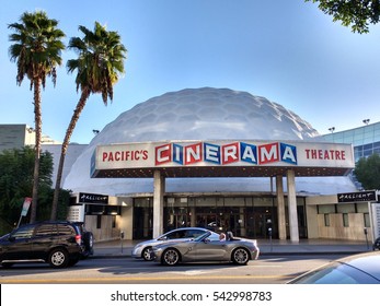 LOS ANGELES, DEC 19TH, 2016: A Sports Car Drives Past He Famous Cinerama Dome Movie Theater On Sunset Boulevard In Hollywood.