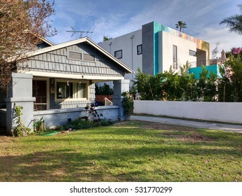 LOS ANGELES, DEC 2ND, 2016: In This Example Of Gentrification In Los Angeles Neighborhoods Such As Hollywood, A Newly Built, Rainbow-colored Mansion Stands Next To A An Old, Decrepit Wooden Structure.