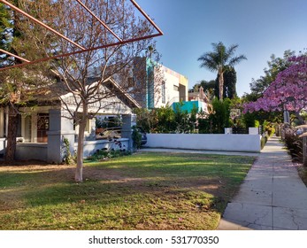 LOS ANGELES, DEC 2ND, 2016: In This Example Of Gentrification In Los Angeles Neighborhoods Such As Hollywood, A Newly Built, Rainbow-colored Mansion Stands Next To A An Old, Decrepit Wooden Structure.