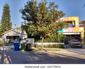 LOS ANGELES, DEC 2ND, 2016: In This Example Of Gentrification In Los Angeles Neighborhoods Such As Hollywood, A Newly Built, Rainbow-colored Mansion Stands Next To A An Old, Decrepit Wooden Structure.