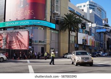 LOS ANGELES, FEB 24TH, 2017: A Police Officer Directs A Car At The Hollywood And Highland Intersection And Mall With Hollywood Boulevard Closed Off During Preparations For The 89th Academy Awards.