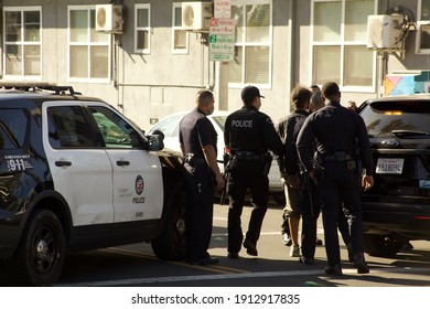 Los Angeles - January 8, 2021:
LAPD officers walk a suspect to a patrol car on Hollywood Boulevard day exterior