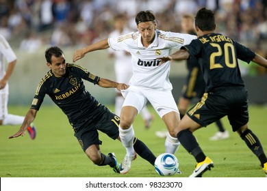 LOS ANGELES - JULY 16: Real Madrid C.F. M Mesut Ozil #23 Tries To Beat The Galaxy Defense During The World Football Challenge Game On July 16 2011 At The Los Angeles Memorial Coliseum In Los Angeles.