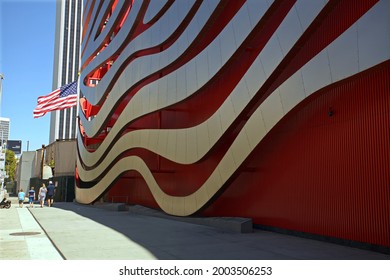 Los Angeles - July 3, 2021: 
A family walks past the Petersen Automotive Museum on Wilshire Blvd. day exterior