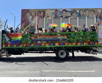LOS ANGELES, 12 de junio de 2022: Desfile del Orgullo Gay de LA Pride 2022 en Hollywood, California. Las leyendas de Hollywood pintadas en una pared de la Escuela Secundaria de Hollywood parecen ver una carroza de Amor es Amor debajo.
