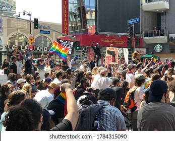 LOS ANGELES, June 14th, 2020: Black Lives Matter Protest On Hollywood Blvd. Man In A Black Panther Costume With Raised Fist Next To BLM Flag Is Speaking To The Crowd In Front Of The Chinese Theater.