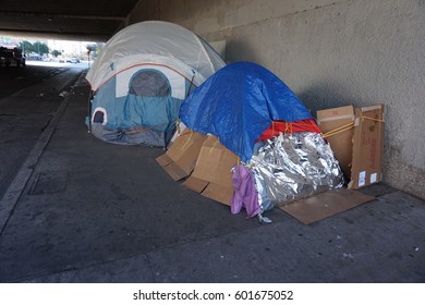 LOS ANGELES, MARCH 1ST, 2017: Close up of tents at a homeless encampment underneath a freeway overpass in downtown Los Angeles.