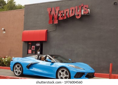 Los Angeles - May 15, 2021: 
Blue Luxury Sports Car At Wendy's Restaurant Pick Up Window