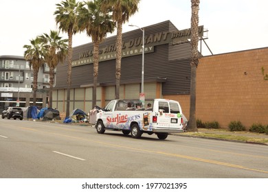 Los Angeles - May 15, 2021: 
Starline Tour Bus Passing Homeless Tents In Hollywood