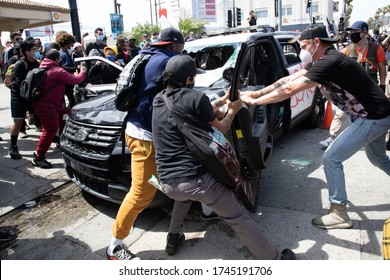 LOS ANGELES - MAY 30, 2020: Unidentified Participants Vandalizing Police Car During The Protest March Against Police Violence Over Death Of George Floyd.