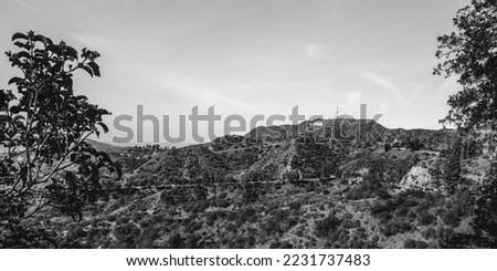 Los Angeles natural woodland park with Hollywood Sign on the Hollywood Hills, view from Griffith Observatory, California, USA, black and white retro-style photo