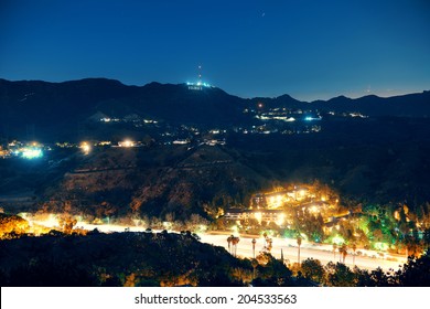 Los Angeles at night with Hollywood sign and highway
