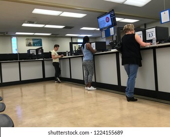 LOS ANGELES, NOV 3rd, 2018: People are standing at the counter inside the DMV field office in Culver City, California.