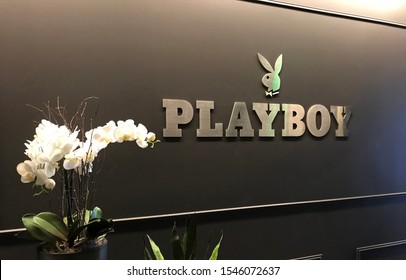 LOS ANGELES, Oct 21st, 2019: Playboy bunny and logo close up on a wall next to white flowers at the magazine's Westwood, California headquarters offices.