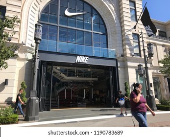 LOS ANGELES, SEP 22, 2018: A woman on her cell phone stands in front of the Nike store at the Grove shopping mall at Third and Fairfax in Los Angeles.
