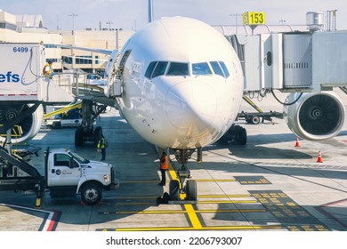 Los Angeles, United States - February 23 2020  : An Airplane Is Parked And Waiting At A Gate And Standing On The Platform With Maintenance Crew Around It