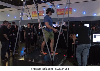 Los Angeles, USA - April 15, 2017: Man walking on the treadmill in virtual reality wearing futuristic VR headset during the VRLA Expo - Virtual Reality Exposition