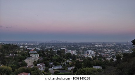 Los Angeles, USA - August 17, 2017: West Hollywood Residential Neighborhood After Sunset With Downtown Los Angeles In The Background, Against A Blue And Violet Evening Sky.