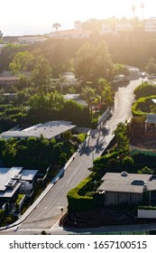 Los Angeles, USA - August 19, 2018: Empty Road, High Up In A Residential Neighborhood Of West Hollywood, With Green Trees, On A Summer Evening With Bright Sunlight In The Background.