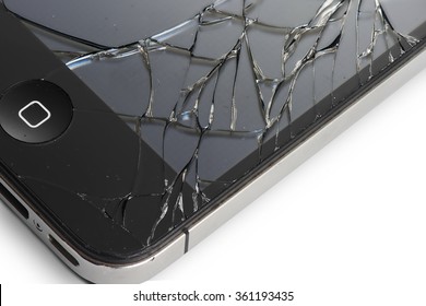 LOS ANGELES , USA - JANUARY 11, 2016 Macro photo of an iPhone 4 with broken display screen isolated on white iPhone 4 is a smartphone developed by Apple Inc.