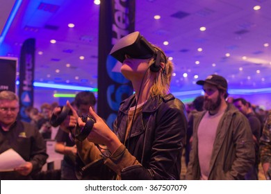 Los Angeles, USA - January 23, 2016: Woman tries virtual reality Samsung Gear VR headset during VRLA Expo Winter, virtual reality exposition, at the Los Angeles Convention Center.