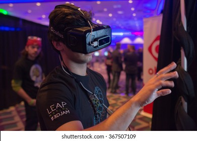 Los Angeles, USA - January 23, 2016: Man tries virtual reality Oculus Rift  headset during VRLA Expo Winter, virtual reality exposition, at the Los Angeles Convention Center.