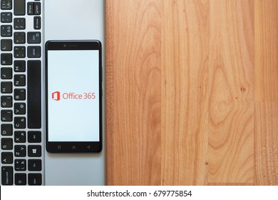 Los Angeles, USA, july 18, 2017: Microsoft office 365 on smartphone screen placed on the laptop on wooden background.