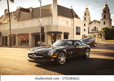 Los Angeles, Year 2017: Front View Of A Black Mercedes-Benz SLS AMG Driving In Beverly Hills. Sunset Time.