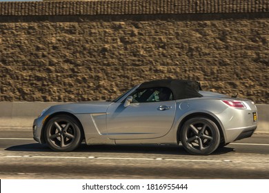 Los Angeles, Year 2017: Side View Of A Silver Saturn Sky Driving On Highway. American Roadster.