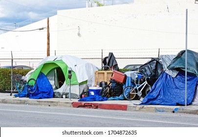 LOS ANGELES/CALIFORNIA -APRIL 8, 2020: Homeless Encampments Along The Roadside Depicting The Growing Epidemic Of Homelessness Amidst The Worldwide Covid-19 Pandemic. Los Angeles,  California USA