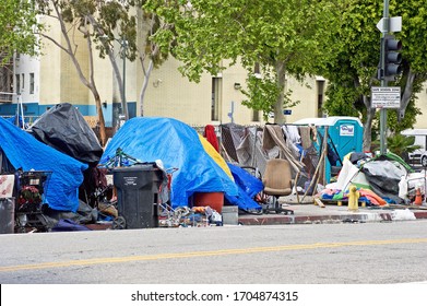 LOS ANGELES/CALIFORNIA -APRIL 8, 2020: Homeless encampments along the roadside depicting the growing epidemic of homelessness amidst the worldwide Covid-19 pandemic. Los Angeles,  California USA