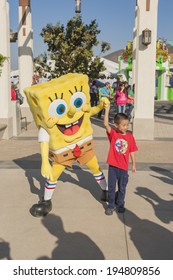 Los Angeles-USA, October, 3: Cartoon Character Sponge Bob Playing with Little Asian Boy at Universal Studios in Los Angeles, California in October, 3, 2013, United States