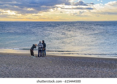 LOS ANTIGUOS, ARGENTINA, MARCH - 2016 - Group Of People Talking At Shore Of Buenos Aires Lake, In Los Antiguos, A Small Town Located In Santa Cruz Province, Argentina