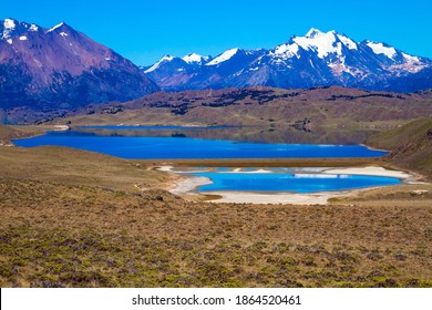 Los Glaciares is Argentina's most beautiful natural park. Pampas surround snow-capped mountains.  Huge lake with azure water and arid steppe of Patagonia - Shutterstock ID 1864520461