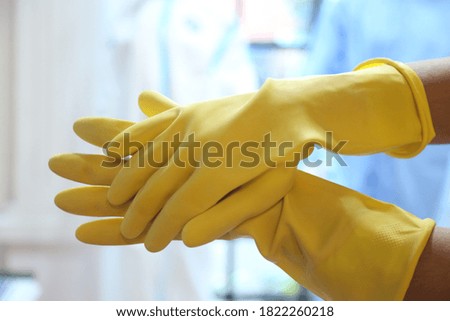 lose up of hand with white latex protective glove offering a handshake