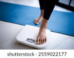 Lose weight. Fat diet and scale feet standing on electronic scales for weight control. Measurement instrument in kilogram for diet.