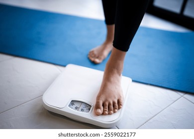 Lose weight. Fat diet and scale feet standing on electronic scales for weight control. Measurement instrument in kilogram for diet.