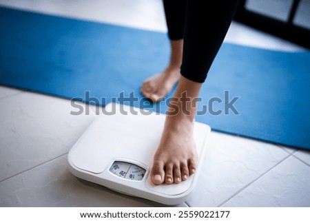 Lose weight. Fat diet and scale feet standing on electronic scales for weight control. Measurement instrument in kilogram for diet.