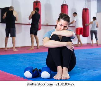 Loser Young Girl Is Sitting On The Floor In The Boxing Hall.