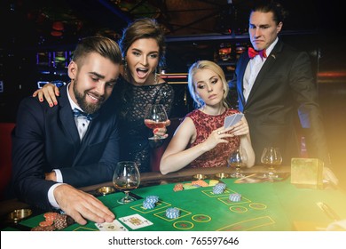 Losers And Winners. Group Of Rich People Is Playing Poker In The Casino. 