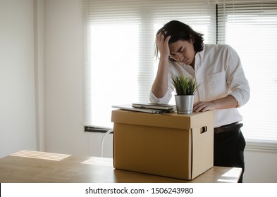 Losing Job. Stressed Asian Young Employee Business Man Leaving The Office With His Personal Stuff Carton Box, Financial Crisis, Unemployed, Last Day At Work, Fired From Job And Lay Off Concept