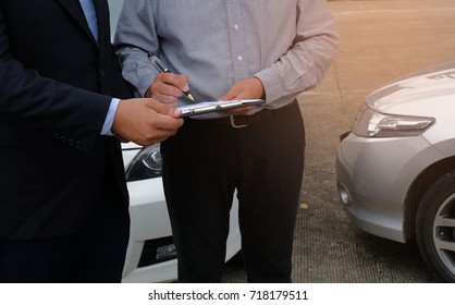 Loss Adjuster Insurance Agent Inspecting Damaged Car 