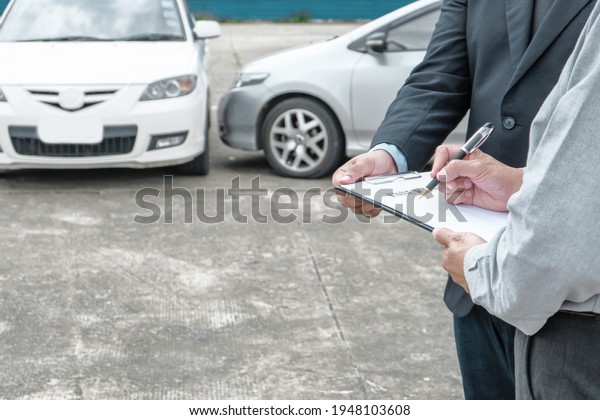 Loss Adjuster Insurance Agent\
Inspecting Damaged Car. \
Sales manager giving advice application\
document considering mortgage loan offer for car  insurance\

