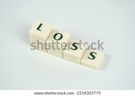 Loss and economic downfall concept, losing money, loss text on white blocks, rising prices and tax idea, crisis and collapse, bad economy, decreasing money value