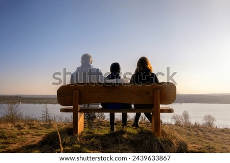 Loss of a family member depicted with slightly transparent man with family on a park bench