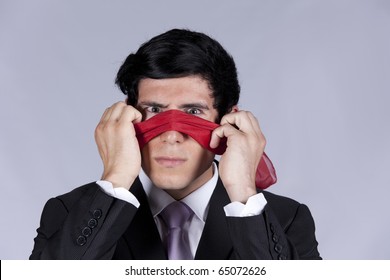 Lost Businessman Peeking Behind A Blindfold